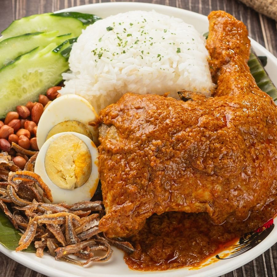 Nanyang Heritage curry chicken nasi lemak with rice, egg, cucumber and anchovies