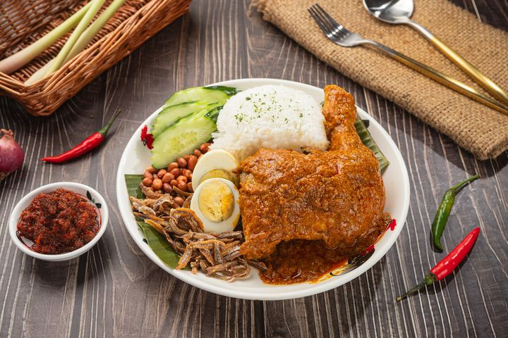 Crispy chicken nasi lemak with coconut rice, egg, cucumber and anchovies