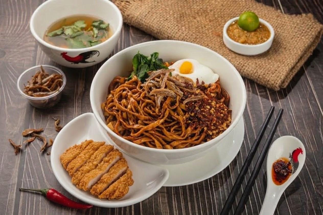 Ms Chin chilli ban mian with egg and greens, served with a crispy chicken cutlet