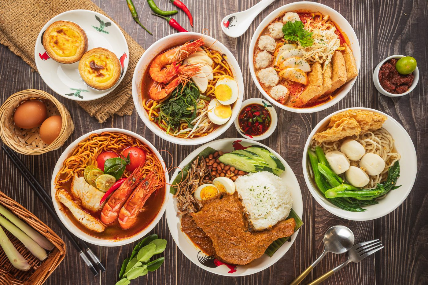 A table spread of Nanyang Heritage rice, noodles and egg tarts